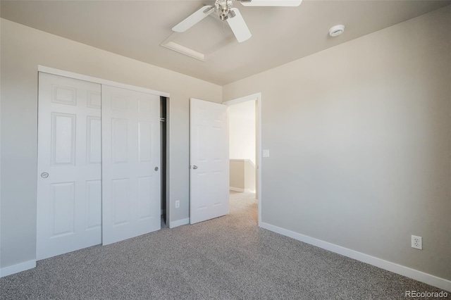 unfurnished bedroom with ceiling fan, carpet flooring, and a closet