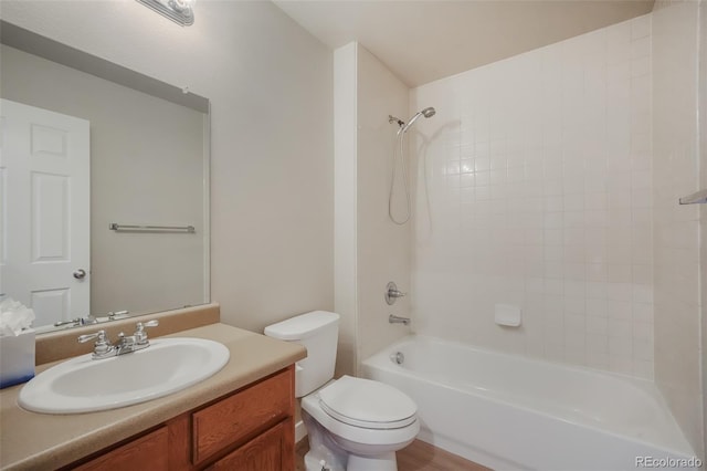 full bathroom with tiled shower / bath combo, vanity, and toilet