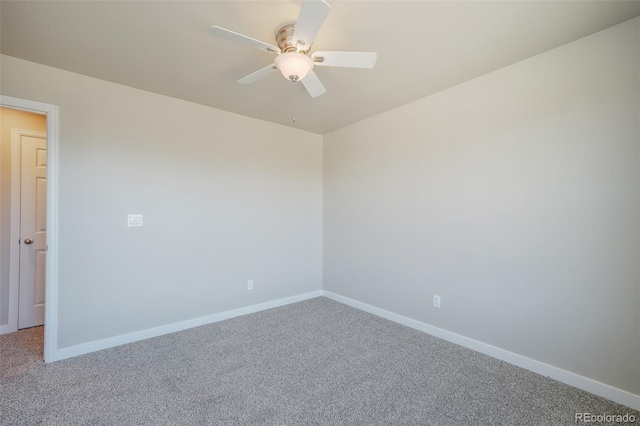 carpeted spare room with ceiling fan