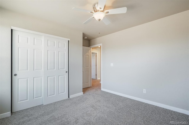 unfurnished bedroom featuring a closet, ceiling fan, and carpet