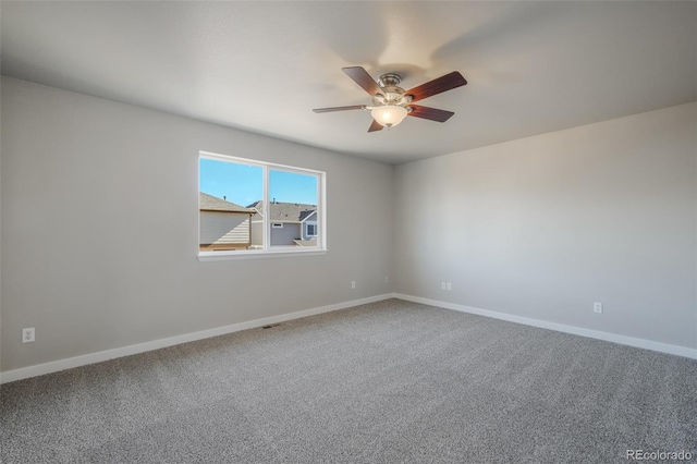 spare room with ceiling fan and carpet