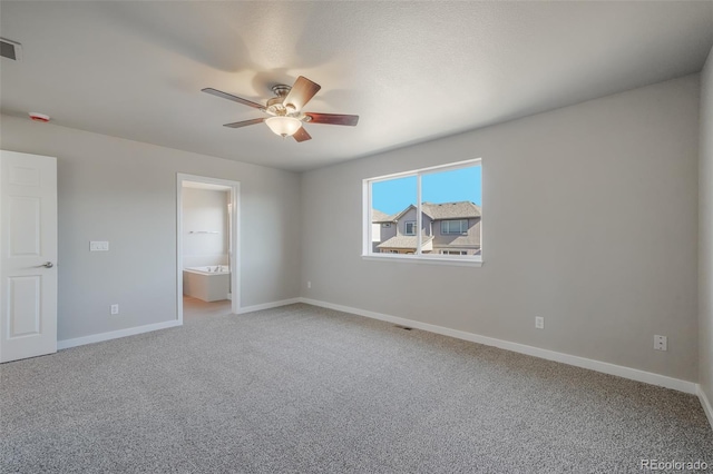 unfurnished bedroom featuring ensuite bathroom, carpet floors, and ceiling fan