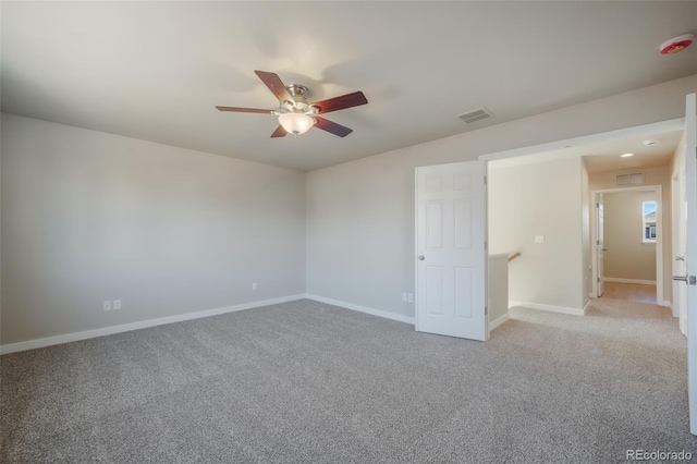 carpeted spare room with ceiling fan