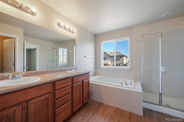 bathroom with vanity, hardwood / wood-style flooring, and separate shower and tub