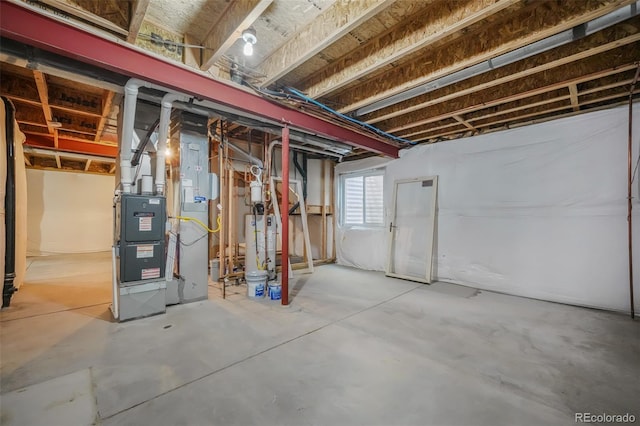 basement featuring water heater and heating unit