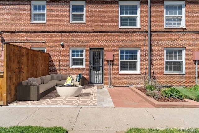 2872 Jasmine St, Denver, CO 80207 - doorway to property with an outdoor living space, brick siding, fence, and a patio