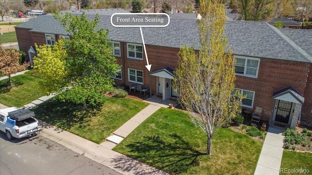 2872 Jasmine St, Denver, CO 80207 - view of property featuring a shingled roof, a front yard, brick siding, and a residential view