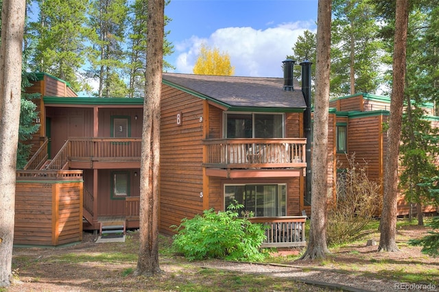 rear view of house featuring a balcony