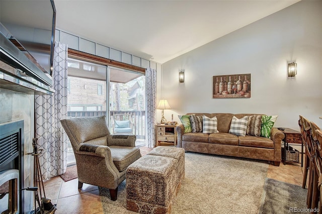 living room featuring lofted ceiling and a fireplace