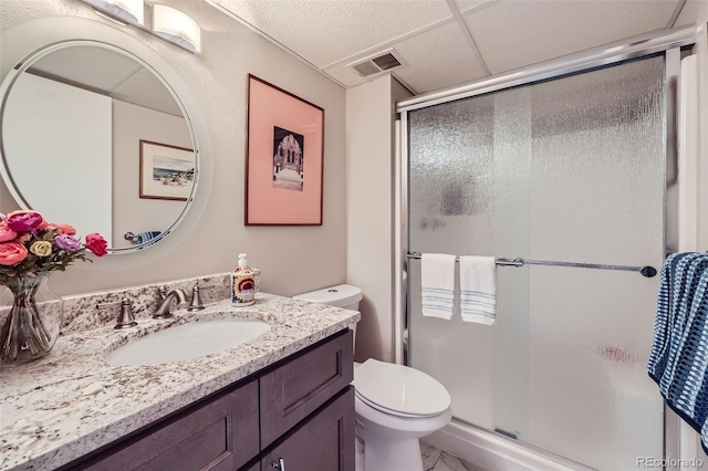 bathroom with toilet, an enclosed shower, and vanity