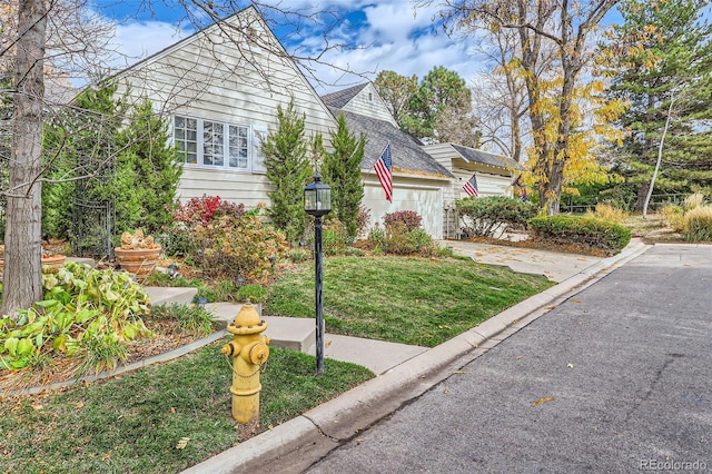 bungalow-style home featuring a garage and a front lawn