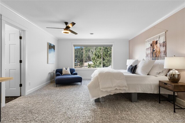 carpeted bedroom featuring baseboards, ornamental molding, and a ceiling fan