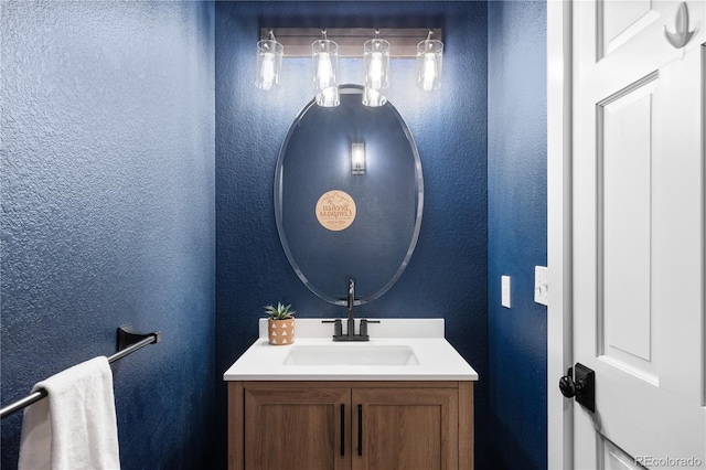 bathroom with vanity and a textured wall