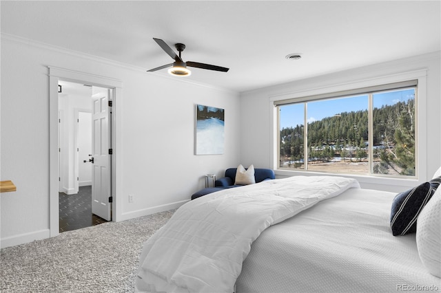 carpeted bedroom featuring visible vents, ceiling fan, baseboards, and ornamental molding