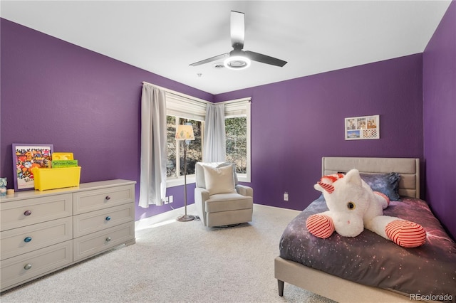 carpeted bedroom featuring baseboards and ceiling fan