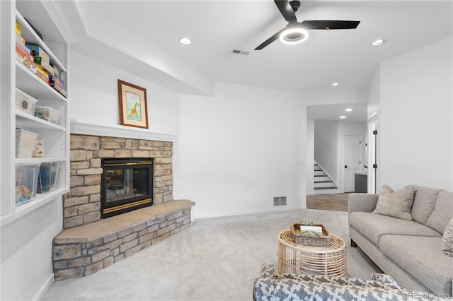 living area with visible vents, carpet flooring, and a fireplace