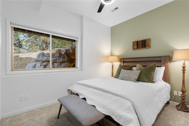 carpeted bedroom featuring a ceiling fan, baseboards, and visible vents