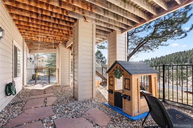 view of patio / terrace featuring an outdoor structure and fence