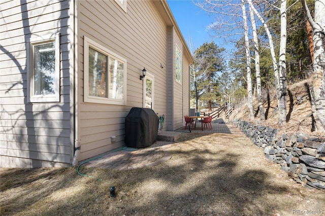 view of side of home featuring a patio area