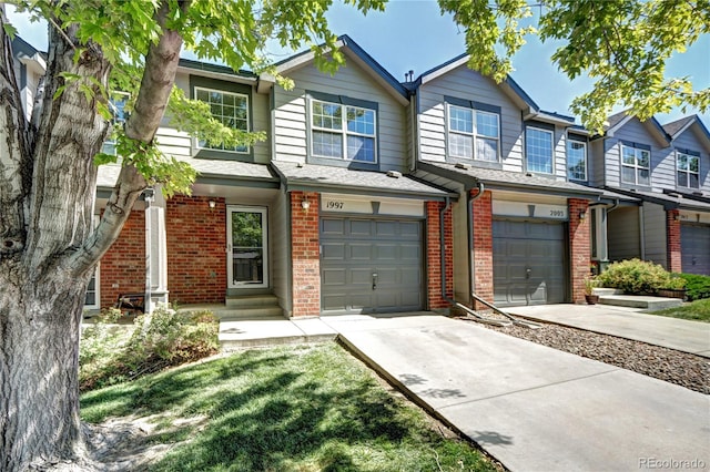 1997 E 102nd Cir, Thornton, CO 80229 - view of front of home with an attached garage, brick siding, and driveway