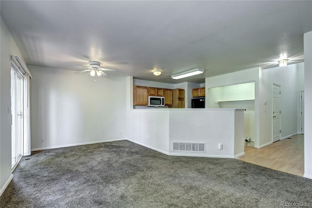 1997 E 102nd Cir, Thornton, CO 80229 - unfurnished living room featuring carpet floors and a ceiling fan