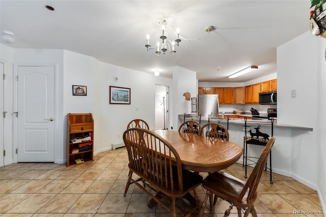 dining room with light tile patterned floors, a chandelier, and baseboards