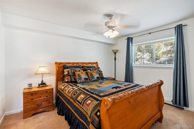 bedroom with light carpet, baseboards, and a ceiling fan
