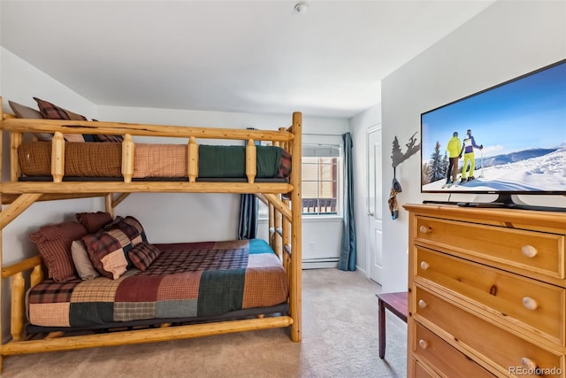 bedroom with light carpet and a baseboard heating unit