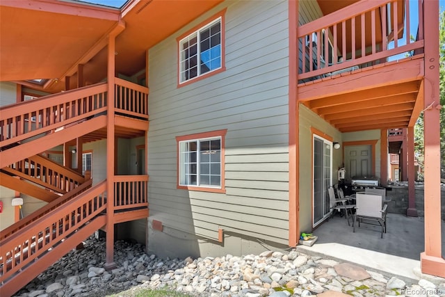 view of side of property with a patio area and a balcony