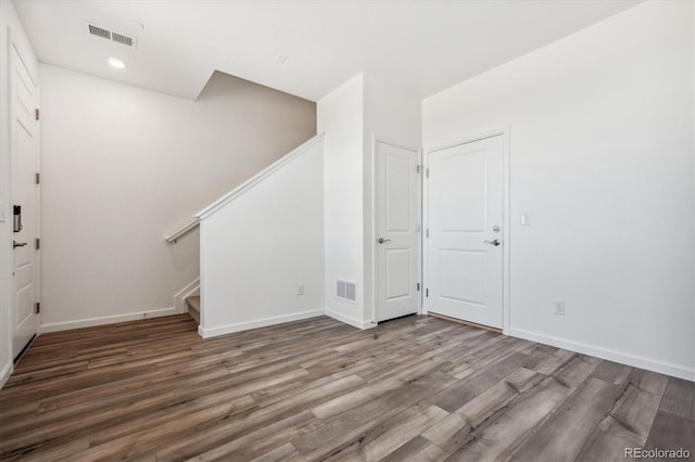 6940 Merseyside Ln, Castle Pines, CO 80108 - foyer with wood finished floors, stairway, and recessed lighting