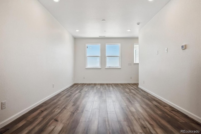 empty room with dark wood-type flooring