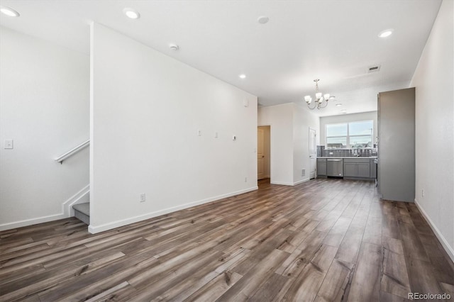 6940 Merseyside Ln, Castle Pines, CO 80108 - unfurnished living room with a chandelier, dark wood-style floors, stairway, and recessed lighting