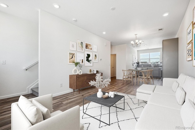 6940 Merseyside Ln, Castle Pines, CO 80108 - living area featuring a chandelier, wood finished floors, stairway, and recessed lighting