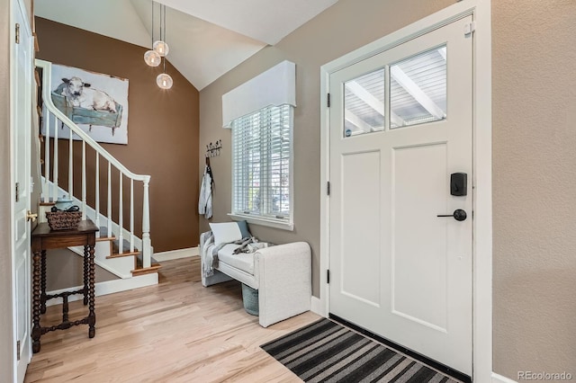 821 S High St, Denver, CO 80209 - entrance foyer featuring light wood-style floors, stairway, lofted ceiling, and baseboards