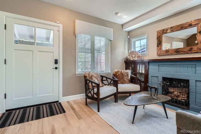 821 S High St, Denver, CO 80209 - entrance foyer featuring light wood-style floors, baseboards, and a fireplace