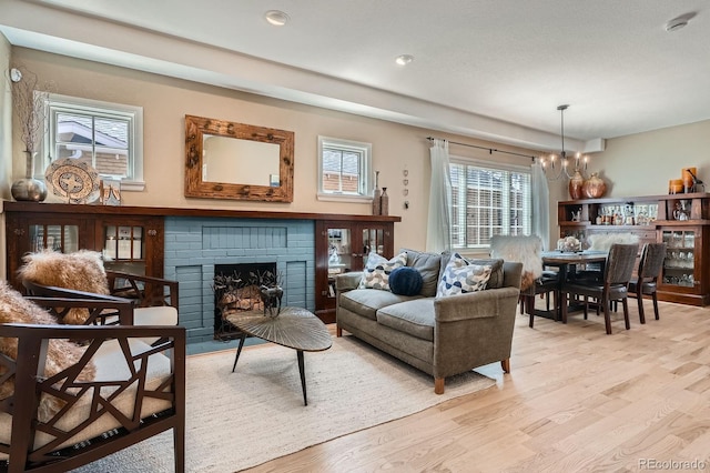821 S High St, Denver, CO 80209 - living area featuring a chandelier, light wood finished floors, a fireplace, and recessed lighting