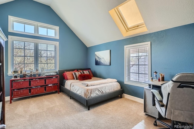821 S High St, Denver, CO 80209 - carpeted bedroom with a skylight, vaulted ceiling, multiple windows, a desk, and baseboards