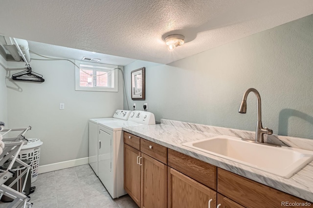 821 S High St, Denver, CO 80209 - laundry room featuring washer and dryer, a textured ceiling, cabinet space, and baseboards