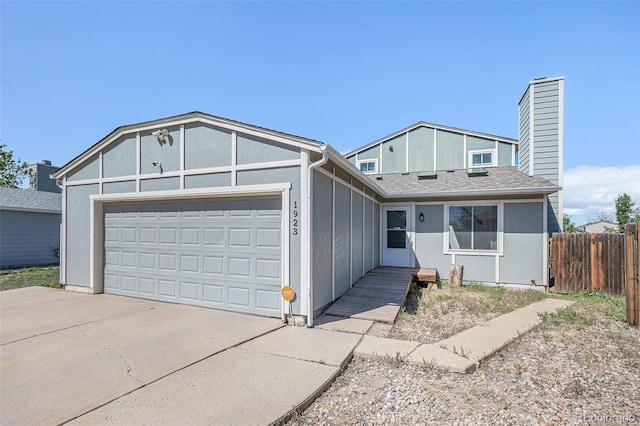 ranch-style home featuring a garage, fence, a chimney, and concrete driveway