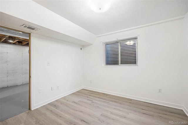 interior space with visible vents, baseboards, and wood finished floors