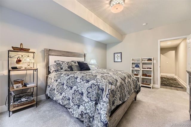 bedroom with light carpet and a textured ceiling