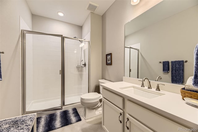 bathroom with tile patterned flooring, vanity, toilet, and walk in shower