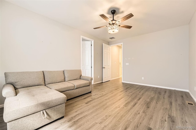 living room with wood-type flooring and ceiling fan