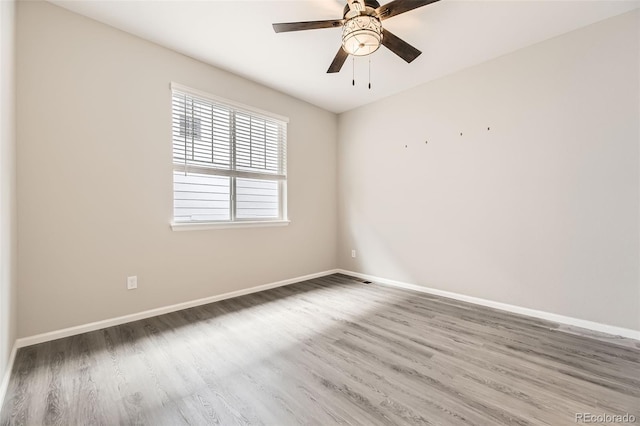 spare room featuring hardwood / wood-style flooring and ceiling fan