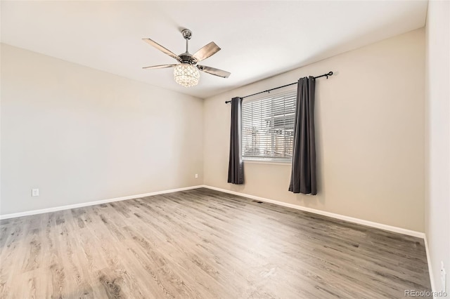 empty room with hardwood / wood-style flooring and ceiling fan