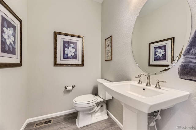 bathroom featuring sink, toilet, and hardwood / wood-style flooring