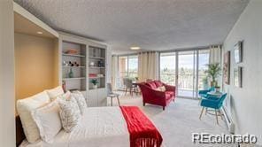 carpeted bedroom featuring multiple windows, access to exterior, and expansive windows