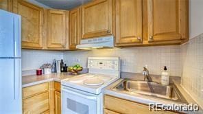 kitchen with sink and white appliances