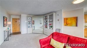 carpeted living room with a textured ceiling