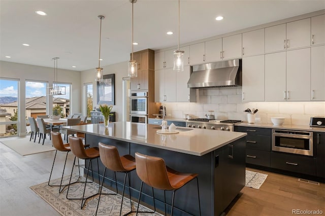 kitchen with white cabinetry, decorative light fixtures, and a kitchen island